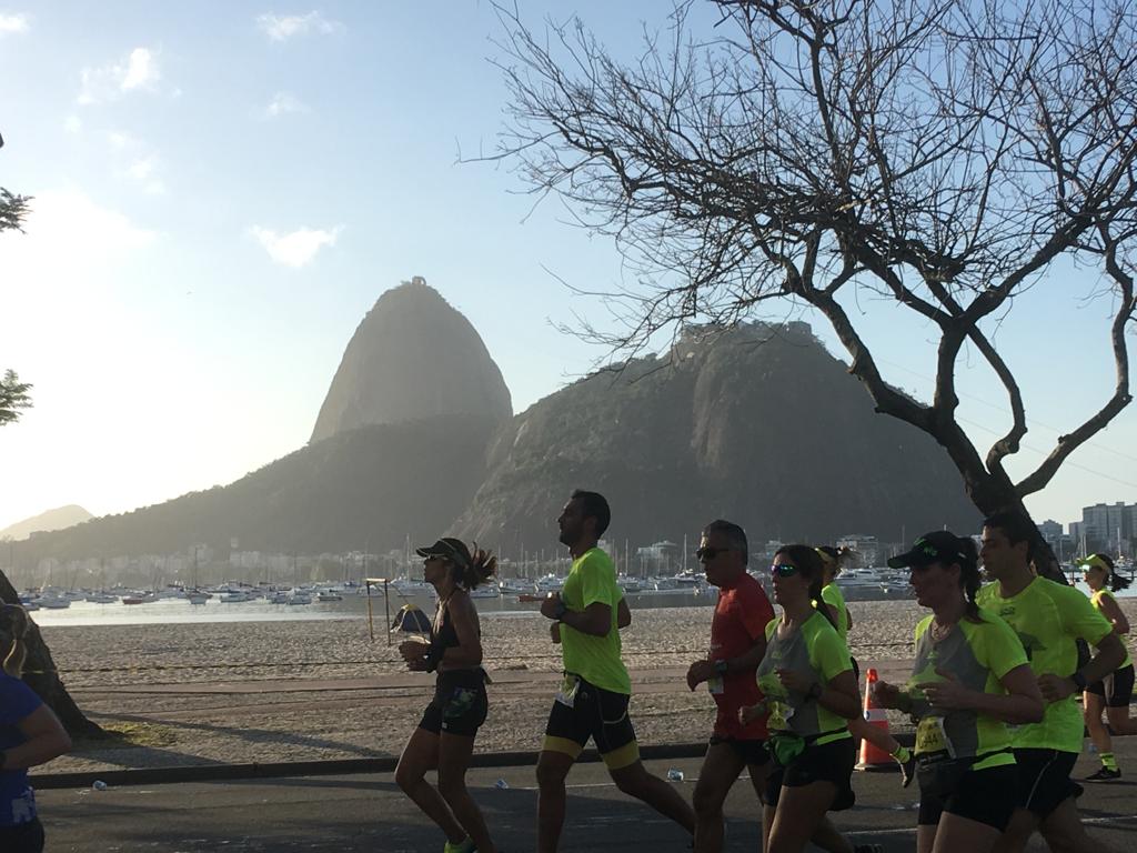 Pessoas correndo com o Pão de Açúcar no fundo - Maratona do Rio